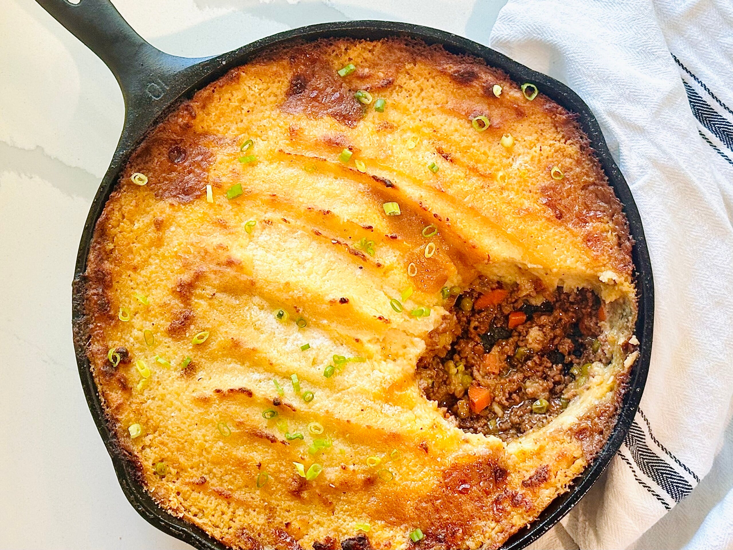 Easy classic shepherd’s pie in cast iron skillet with golden brown potato topping
