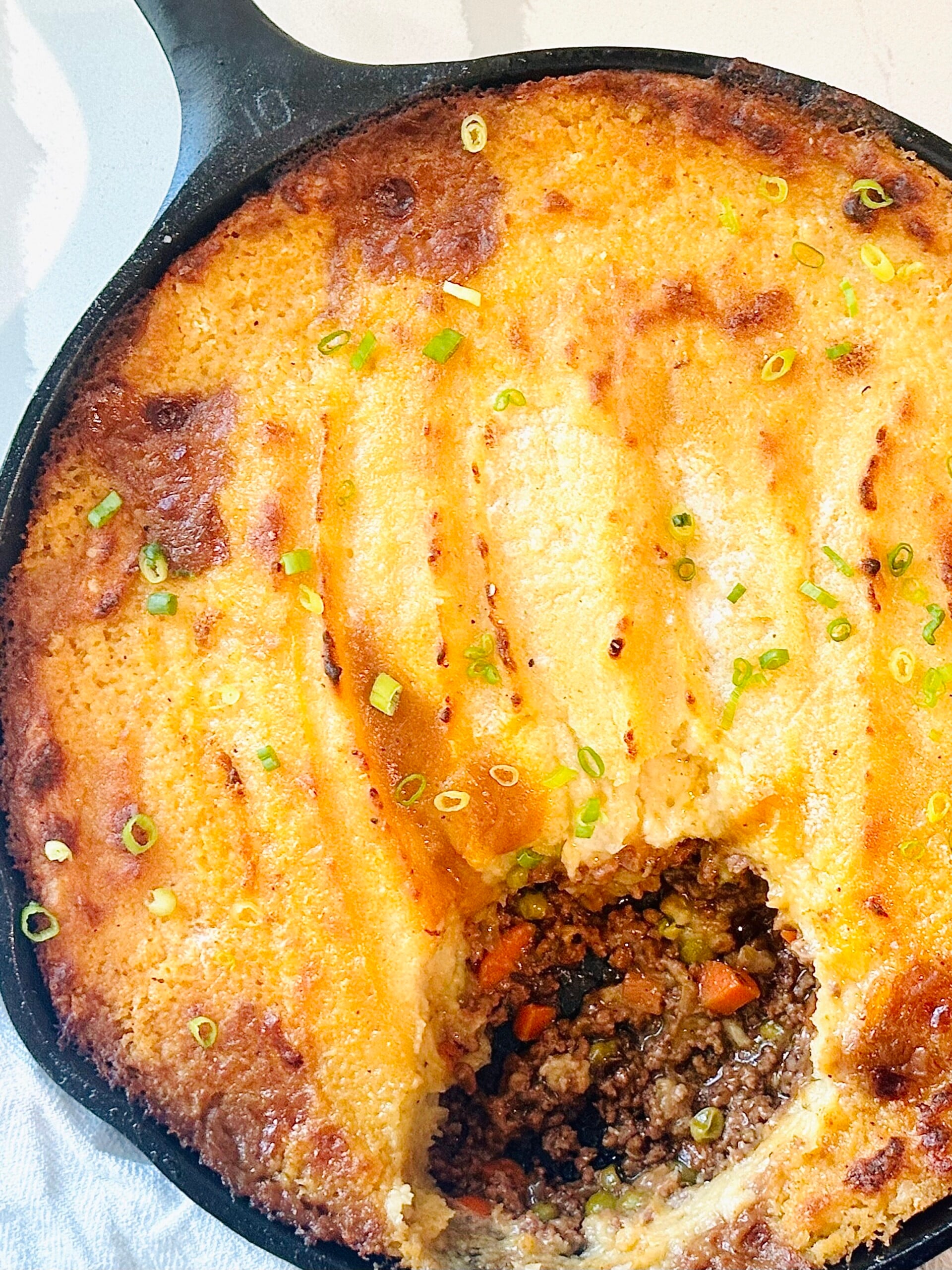 Comfort food shepherd’s pie with cheddar potato topping and visible meat sauce