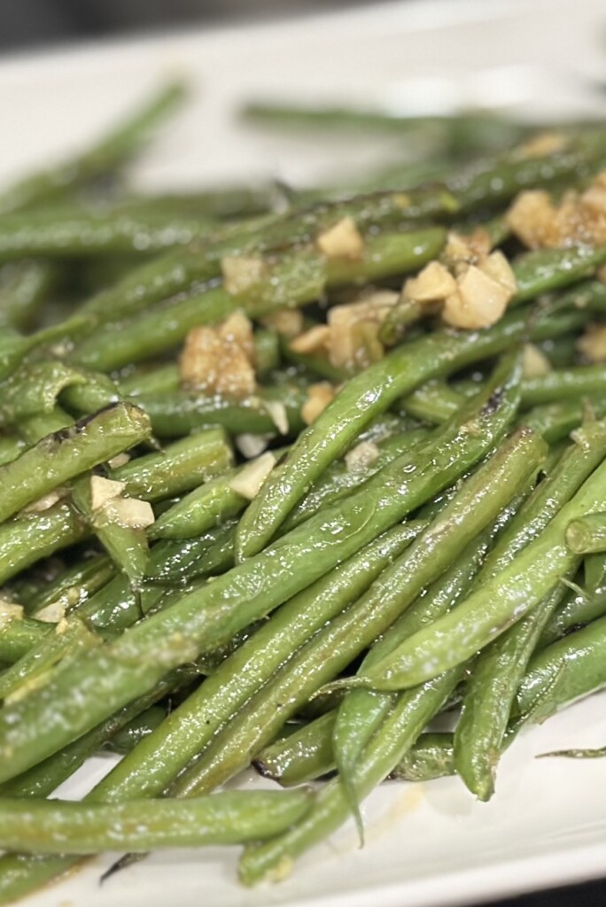 Close up of sauteed garlic butter green beans.