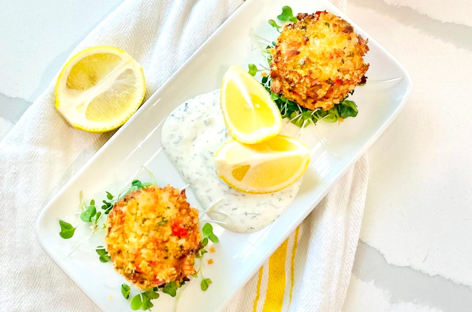 Overhead view of Crab Cakes with Lemon Dill Sauce.