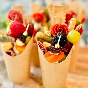 Adorable charcuterie cups filled with deli meat, soft cheeses, fresh fruit, and crackers, perfect for baby showers, game days, or holiday season gatherings.