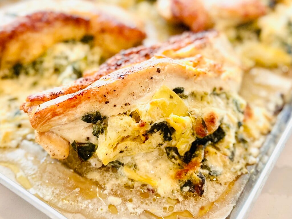 Creamy Spinach Artichoke Stuffed Chicken Breasts baked to a golden brown.