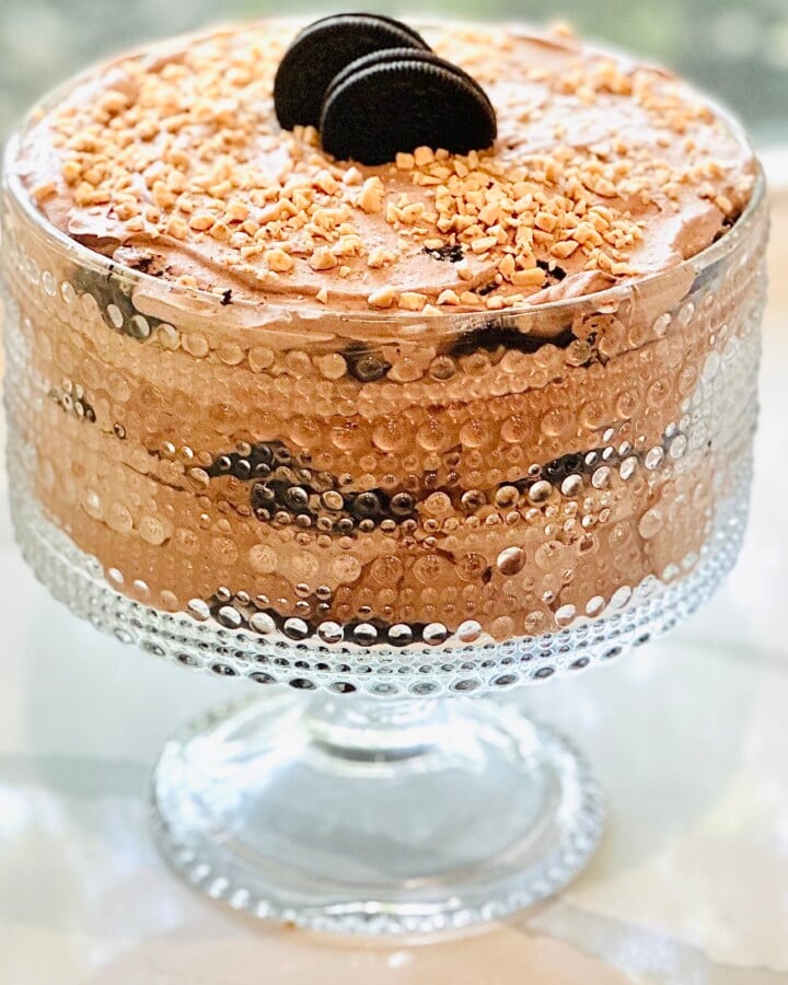 Creamy Baileys chocolate dessert layered with Oreos, cheesecake filling, and whipped cream, finished with toffee topping