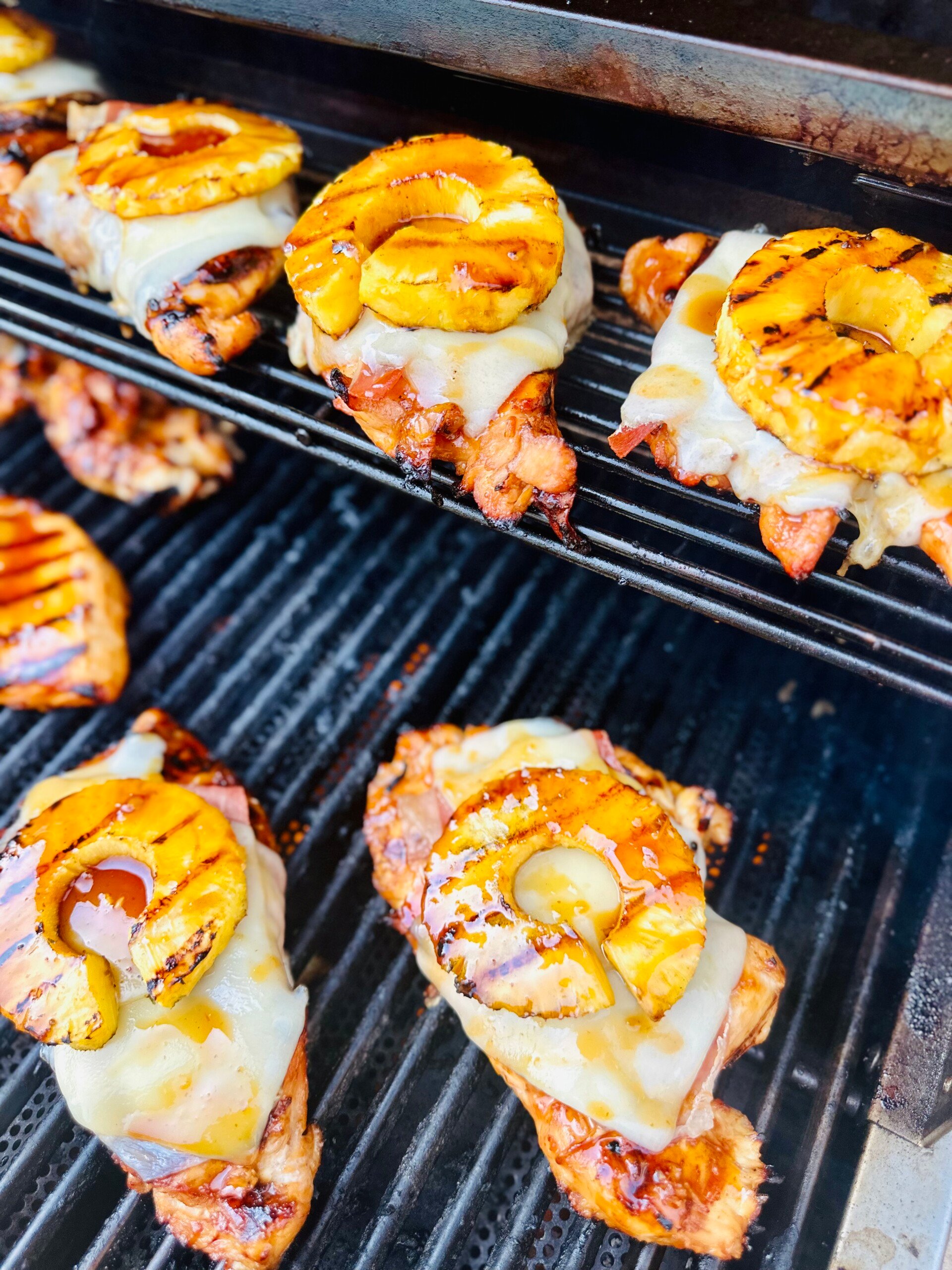 Grilled aloha chicken breast topped with prosciutto, Swiss cheese, and charred pineapple ring