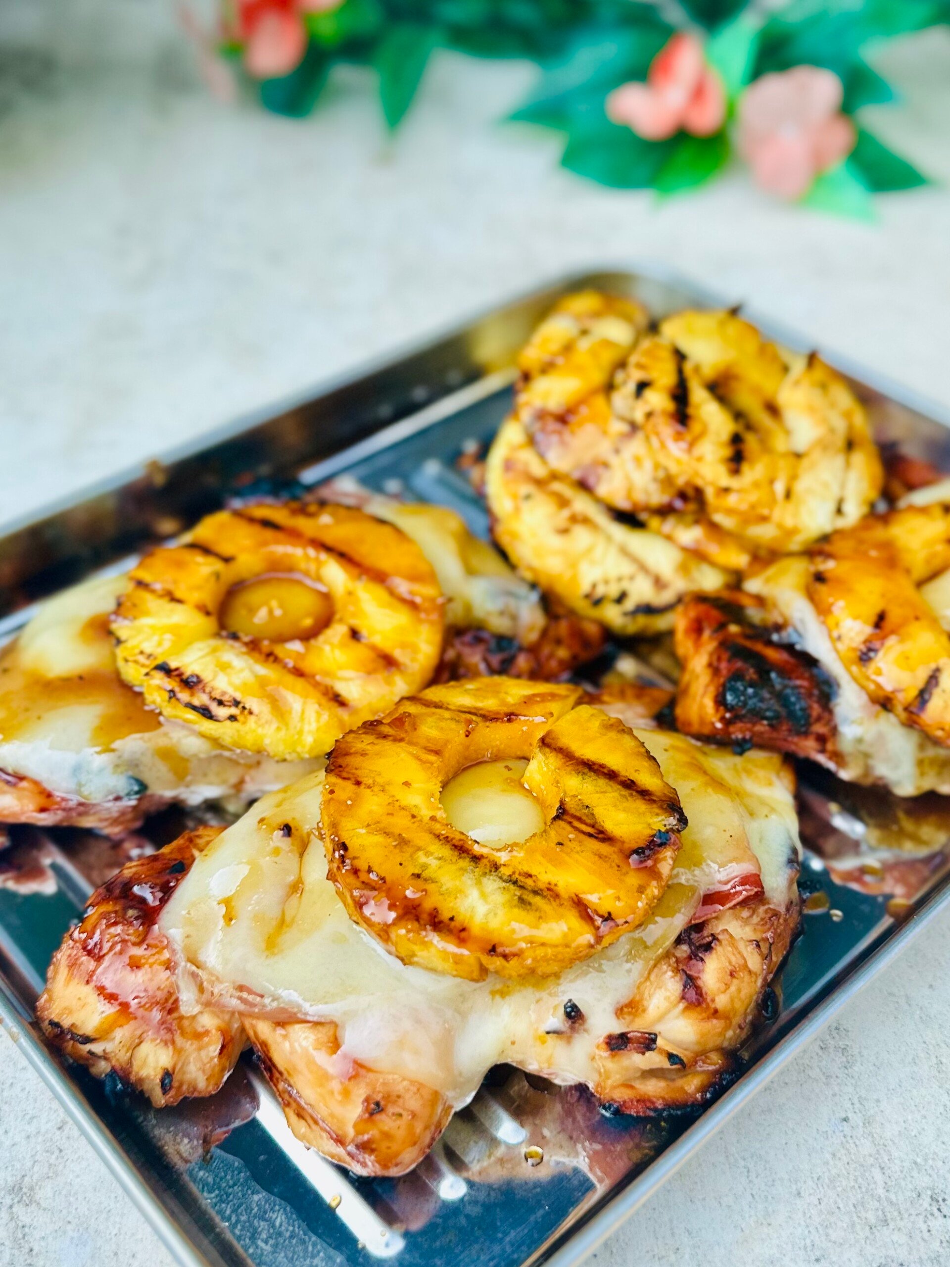 Sweet and savory grilled aloha chicken ready to serve with rice and vegetables