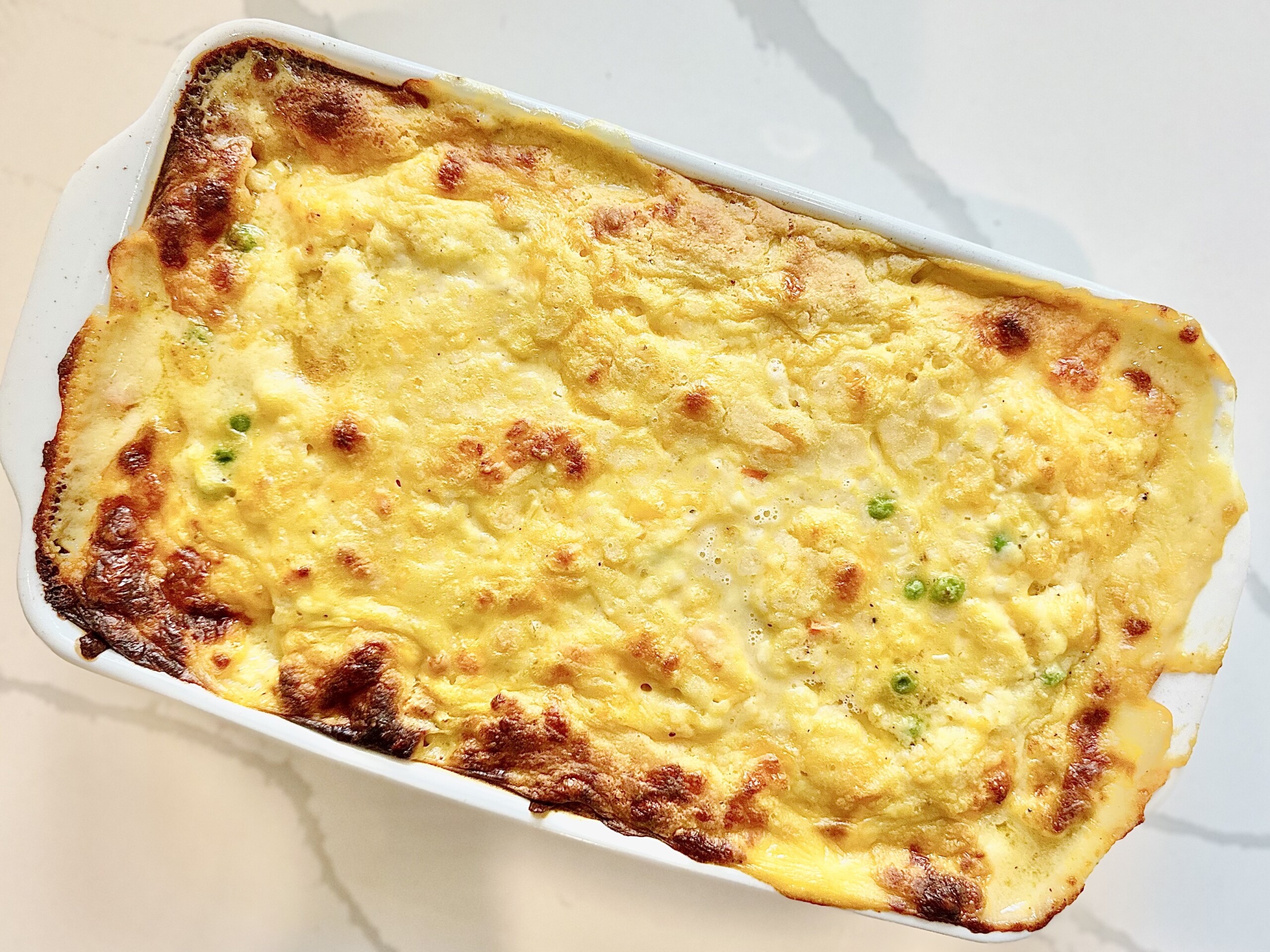 Golden baked chicken cobbler casserole with cheesy biscuit topping fresh from the oven