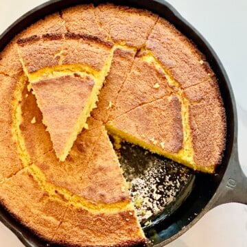 Golden Southern buttermilk cornbread baked in a cast iron skillet, sliced into wedges with a crisp crust.