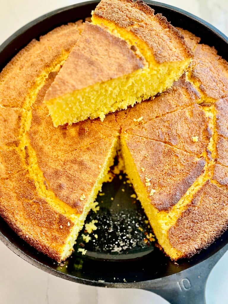 Freshly baked Southern buttermilk cornbread with a golden, buttery crust in a skillet.