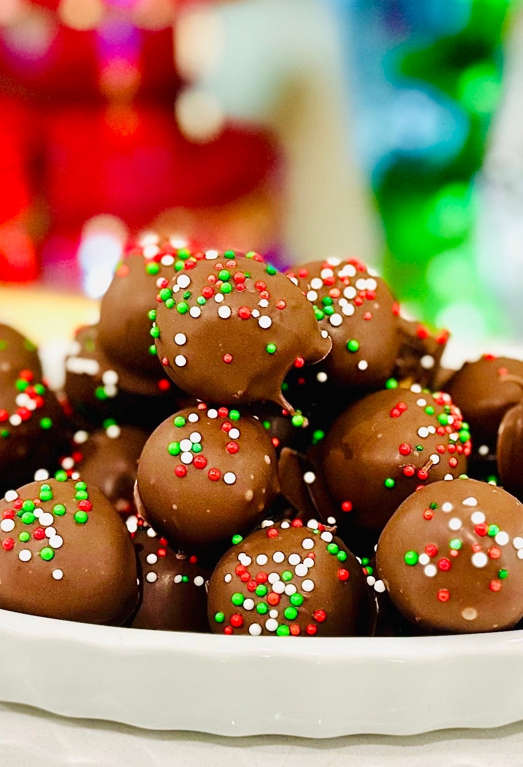 Peanut butter balls stacked high in a white bowl