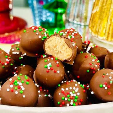 Peanut butter balls stacked high in a white bowl