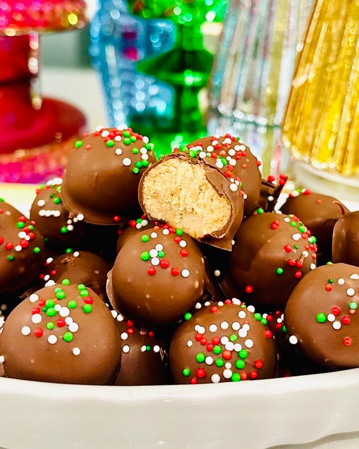 Peanut butter balls stacked high in a white bowl