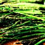 Finished grilled asparagus with garlic and light char marks ready to serve.