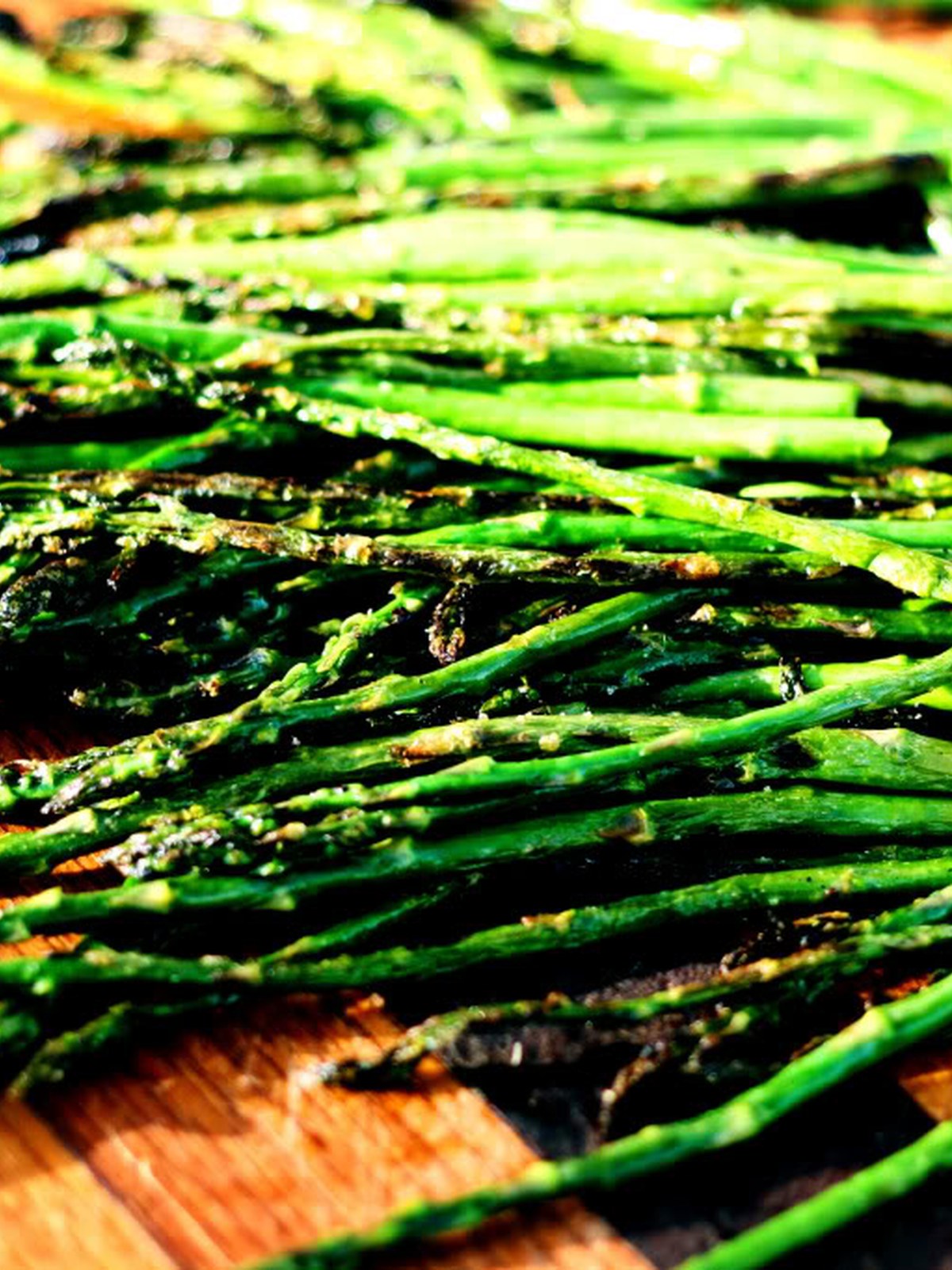 Finished grilled asparagus with garlic and light char marks ready to serve.