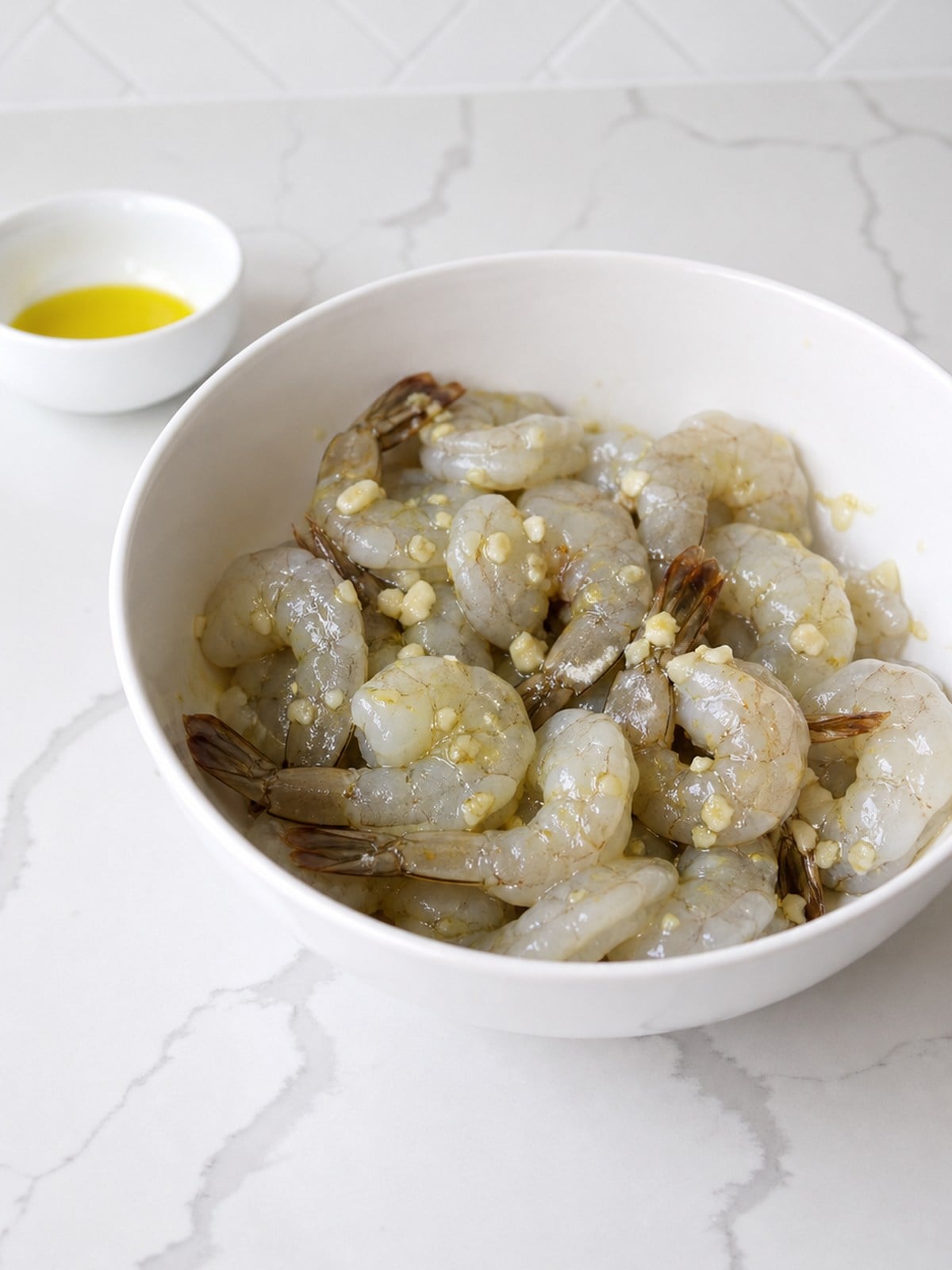 Raw deveined shrimp tossed with olive oil and chopped garlic before adding the spice rub.