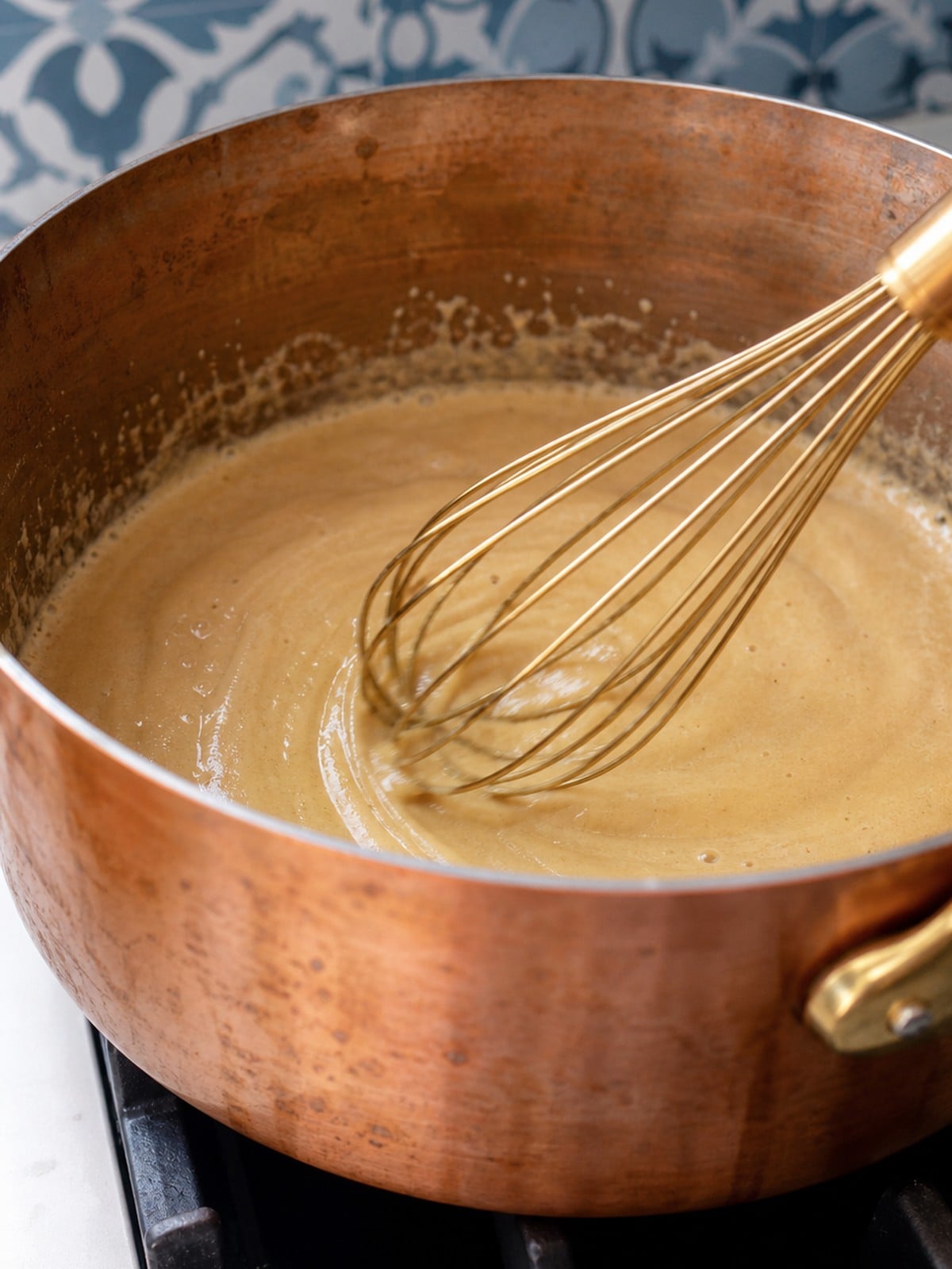 Blonde roux being whisked in a copper saucepan for crawfish etouffee.