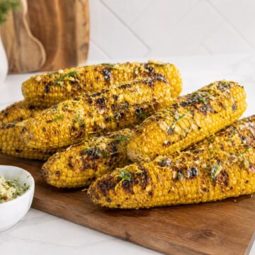 Easy grilled corn on the cob with garlic herb butter and smoky grill marks.