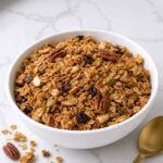 Easy homemade granola with toasted oats, pecans, almonds, pistachios, pepitas, and honey cinnamon coating.