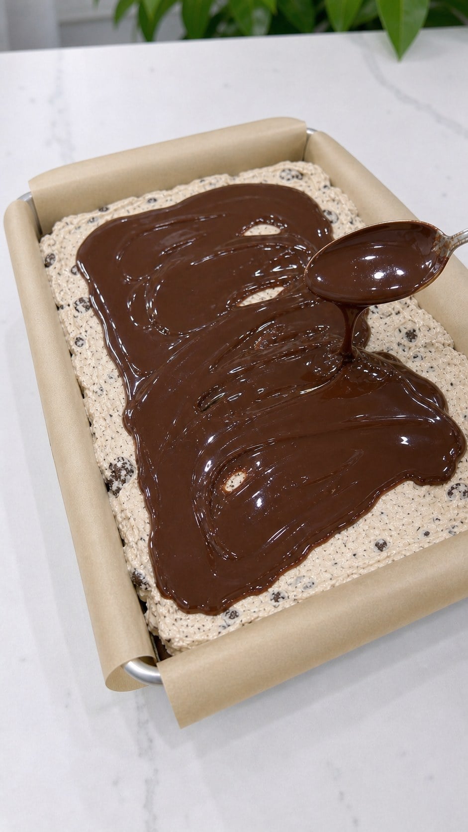 Glossy hot fudge spread over the smooth cookie ice cream layer.