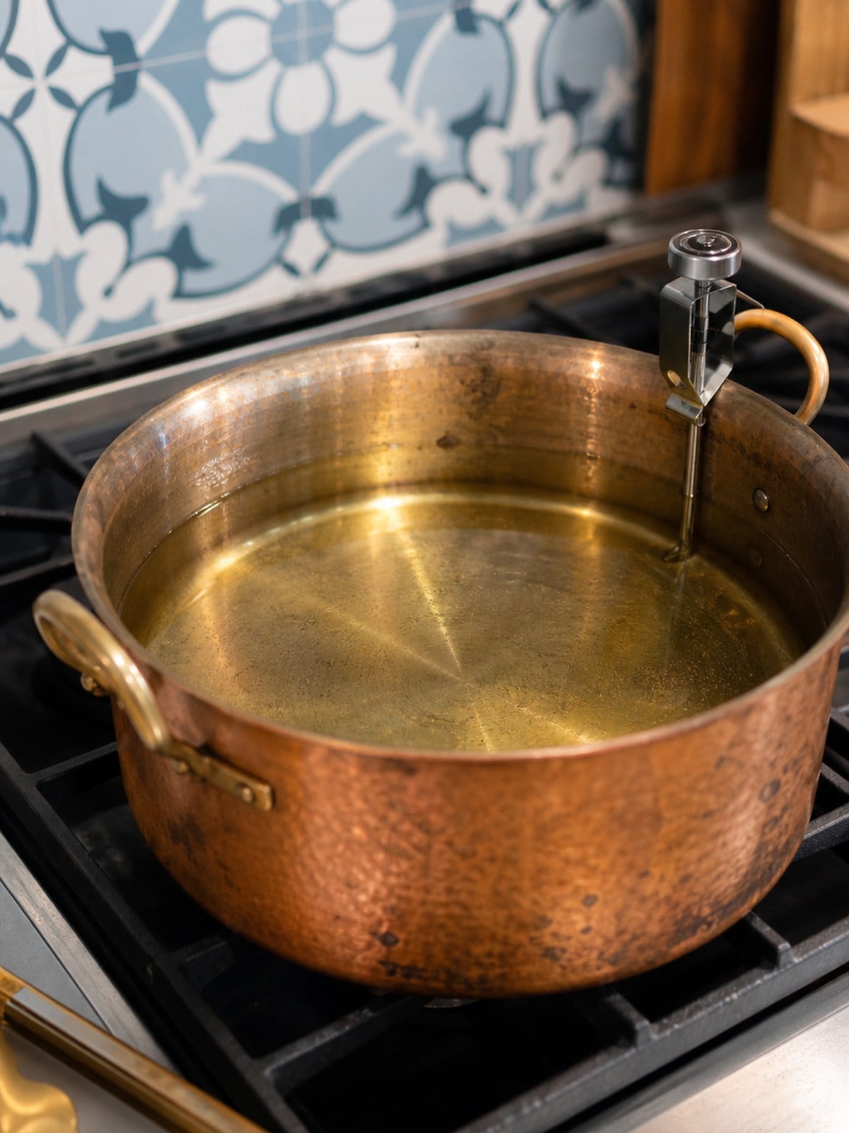 Vegetable oil heating in a heavy pot for frying homemade corn dogs.
