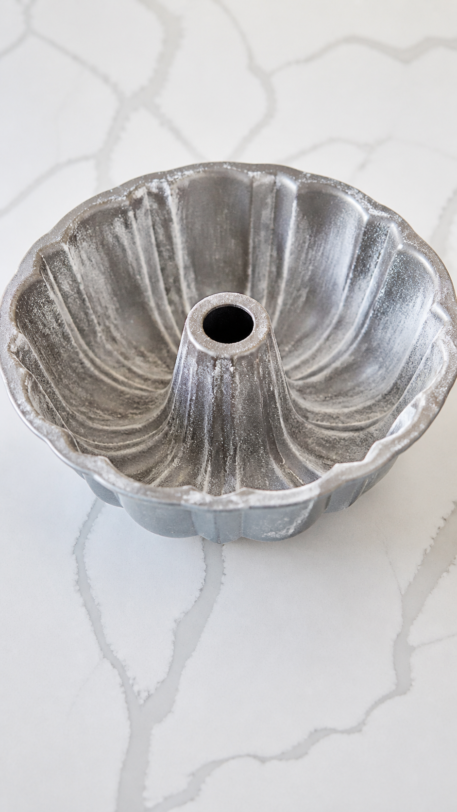 Greased and lightly floured Bundt pan with every groove coated