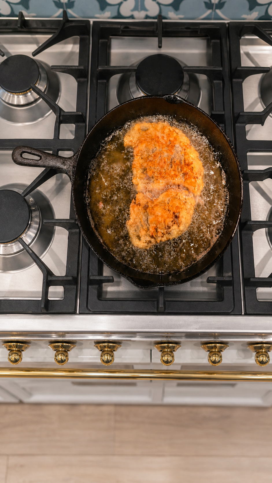 Chicken fried steaks frying until the coating is crisp and deep golden brown.