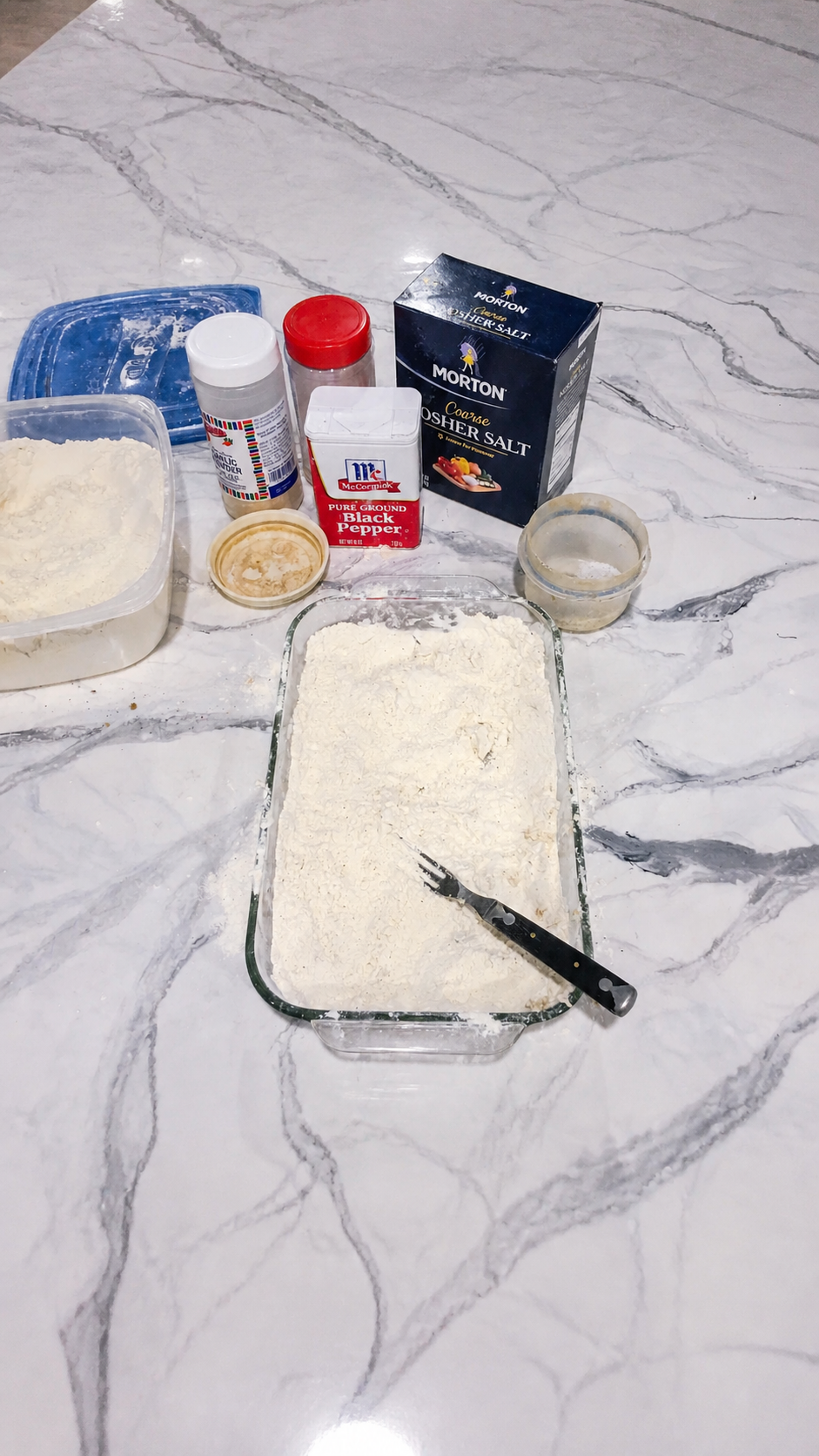Seasoned flour and egg-and-milk mixture arranged for breading chicken fried steak.