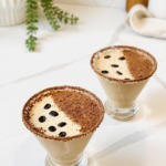 Two creamy Baileys espresso martinis with chocolate rims and coffee beans.