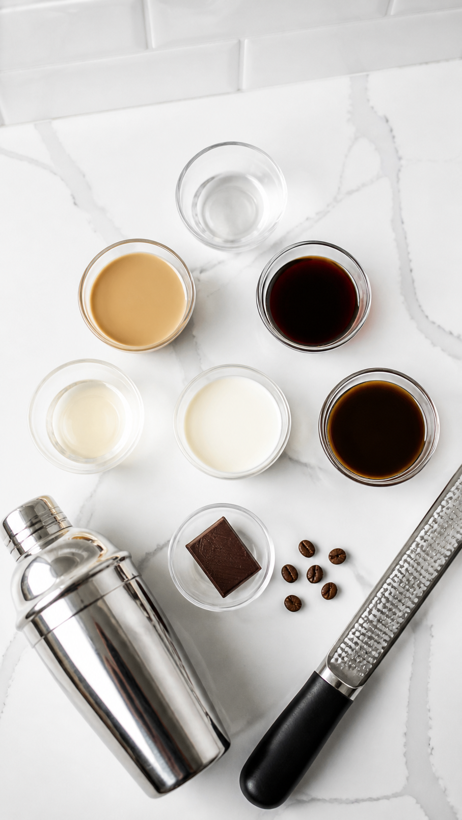 Measured ingredients and tools for creamy Baileys espresso martinis.