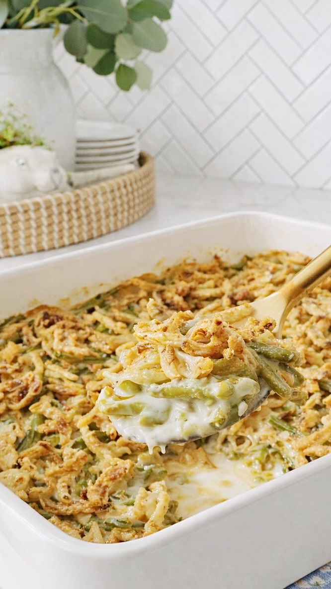 Spoonful of creamy green bean casserole with crisp fried onions