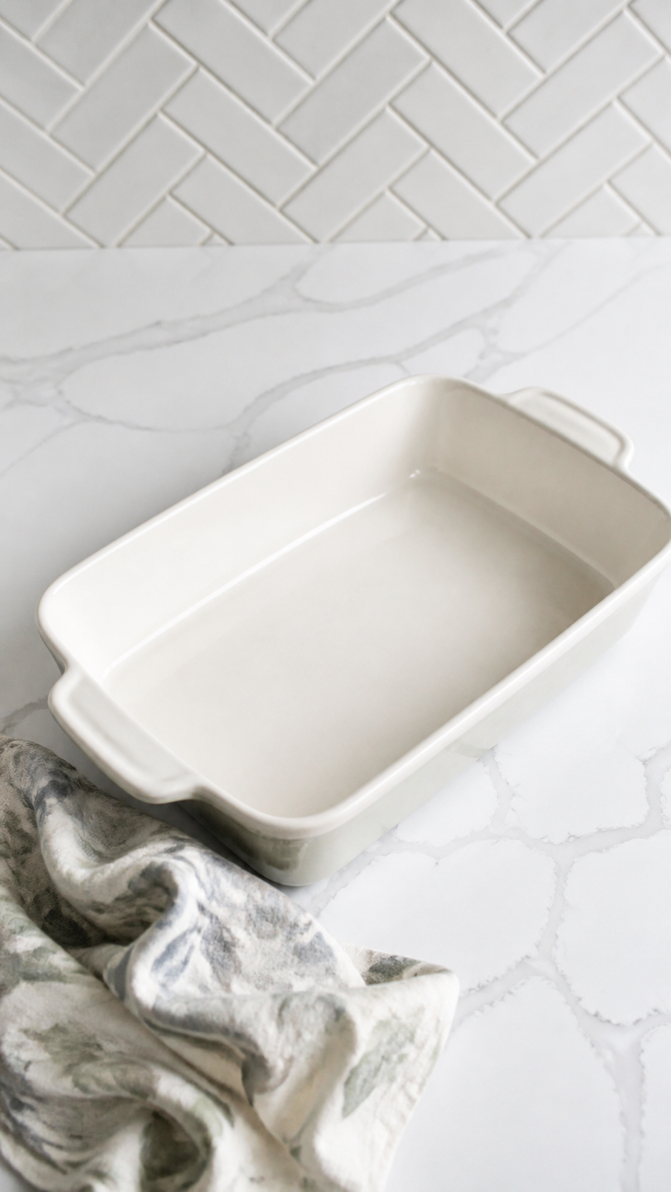 Lightly greased white 2-quart baking dish ready for green bean casserole