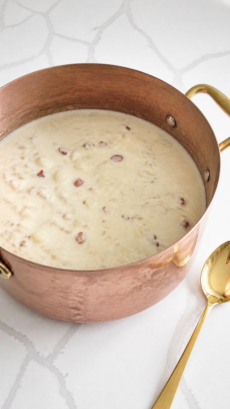 Milk and flour mixture stirred into potatoes and small pieces of canned clams to thicken the chowder.