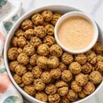 Close-up of deep golden fried okra showing its crisp cornmeal coating and green okra centers.