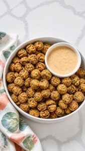 Close-up of deep golden fried okra showing its crisp cornmeal coating and green okra centers.