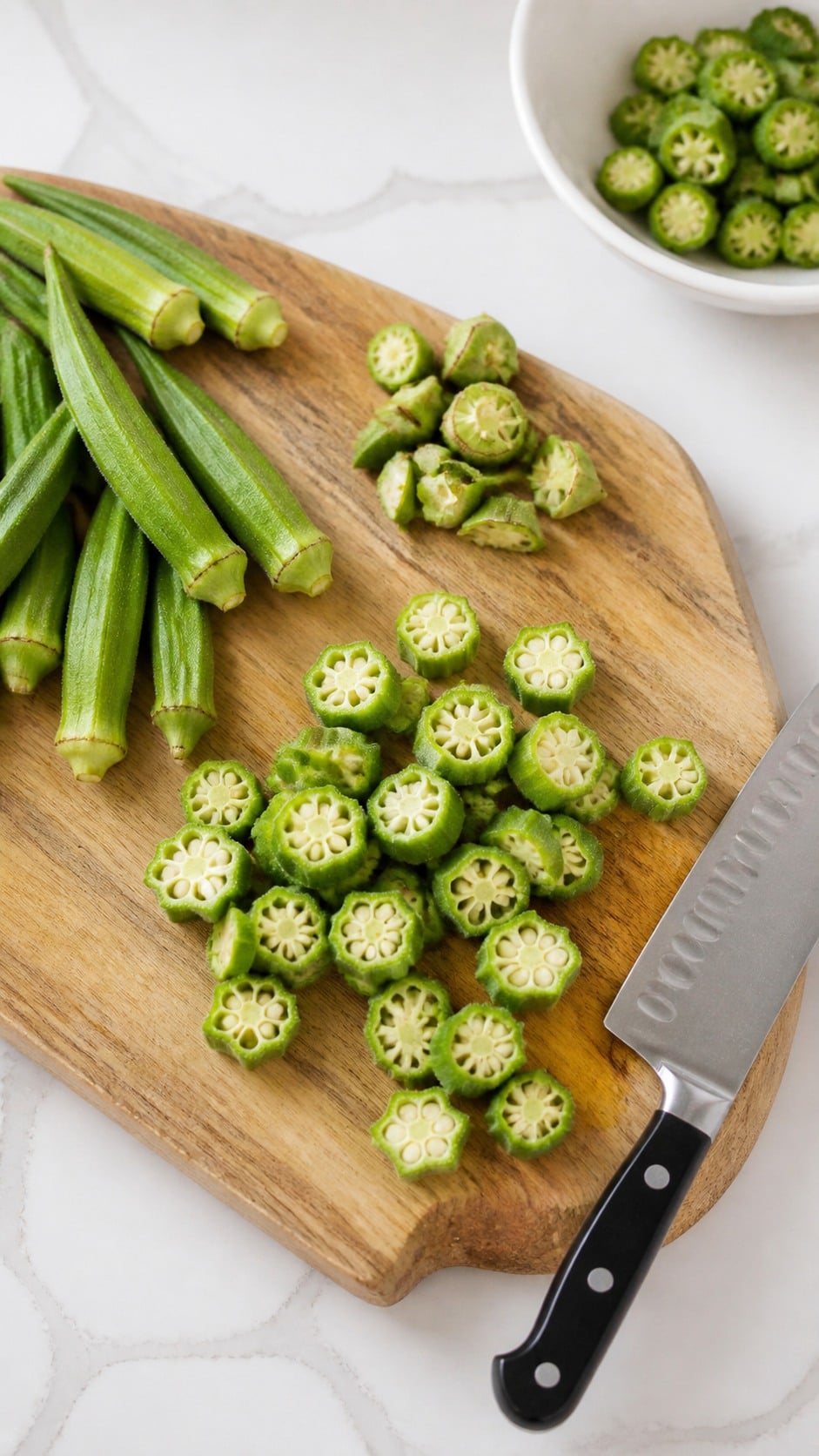 Fresh okra trimmed and sliced into three-quarter-inch rounds for frying.