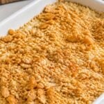 Old-fashioned chicken and rice casserole with a golden buttery Ritz cracker topping in a white baking dish.