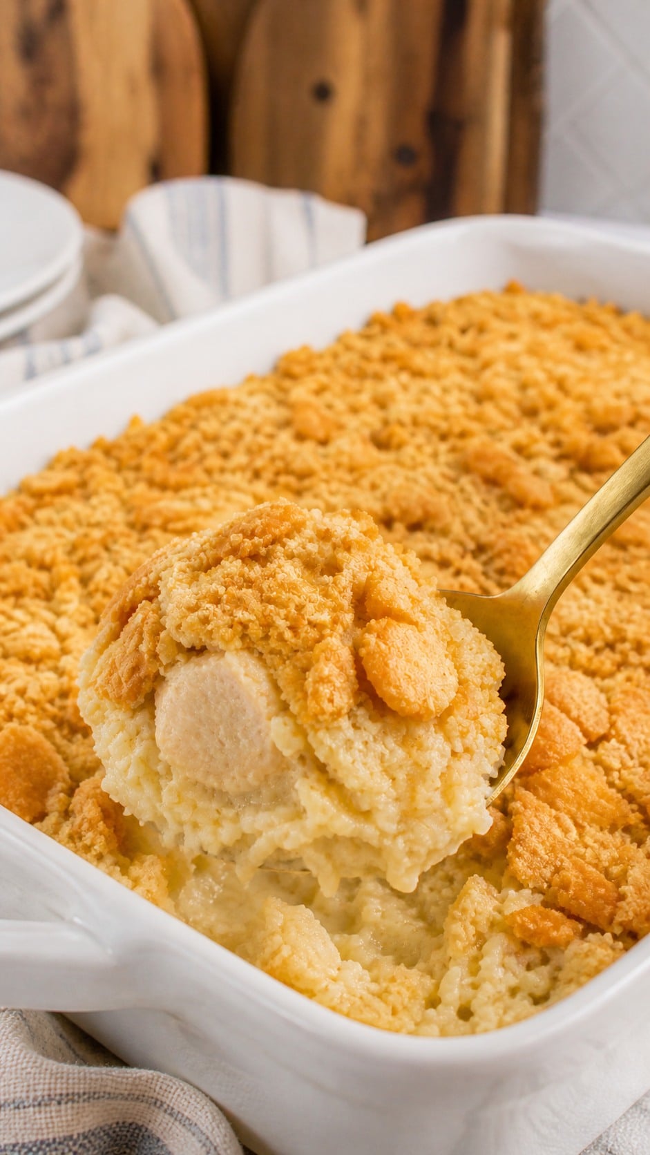Serving of chicken and rice casserole scooped from the baking dish with buttery cracker topping.