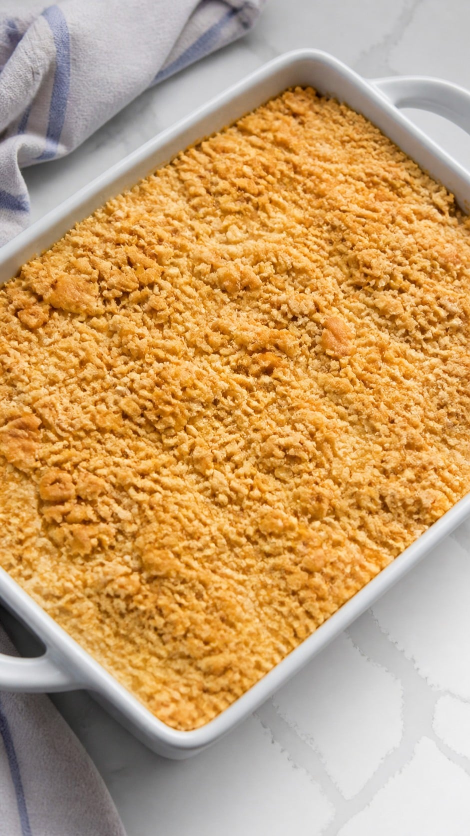 Finished chicken and rice casserole resting after baking with crisp cracker topping.