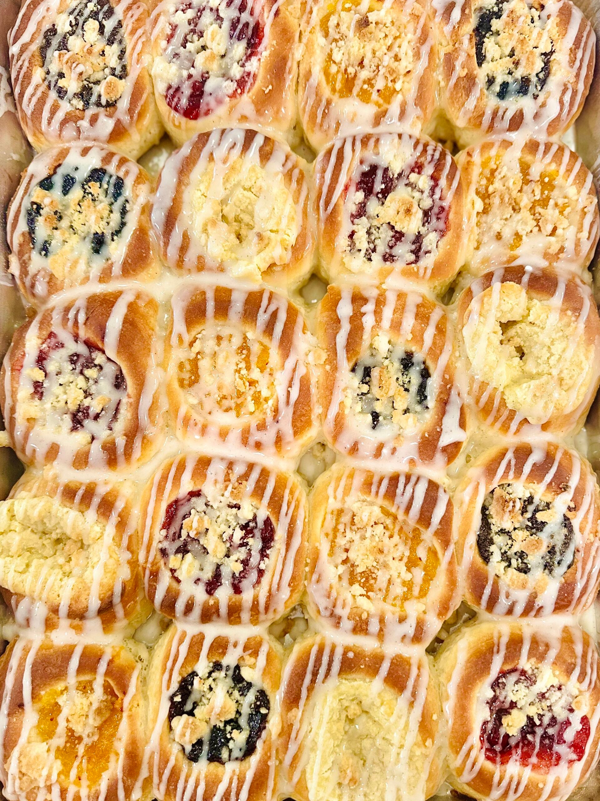 Close overhead view of assorted homemade Texas Czech kolaches finished with vanilla icing.