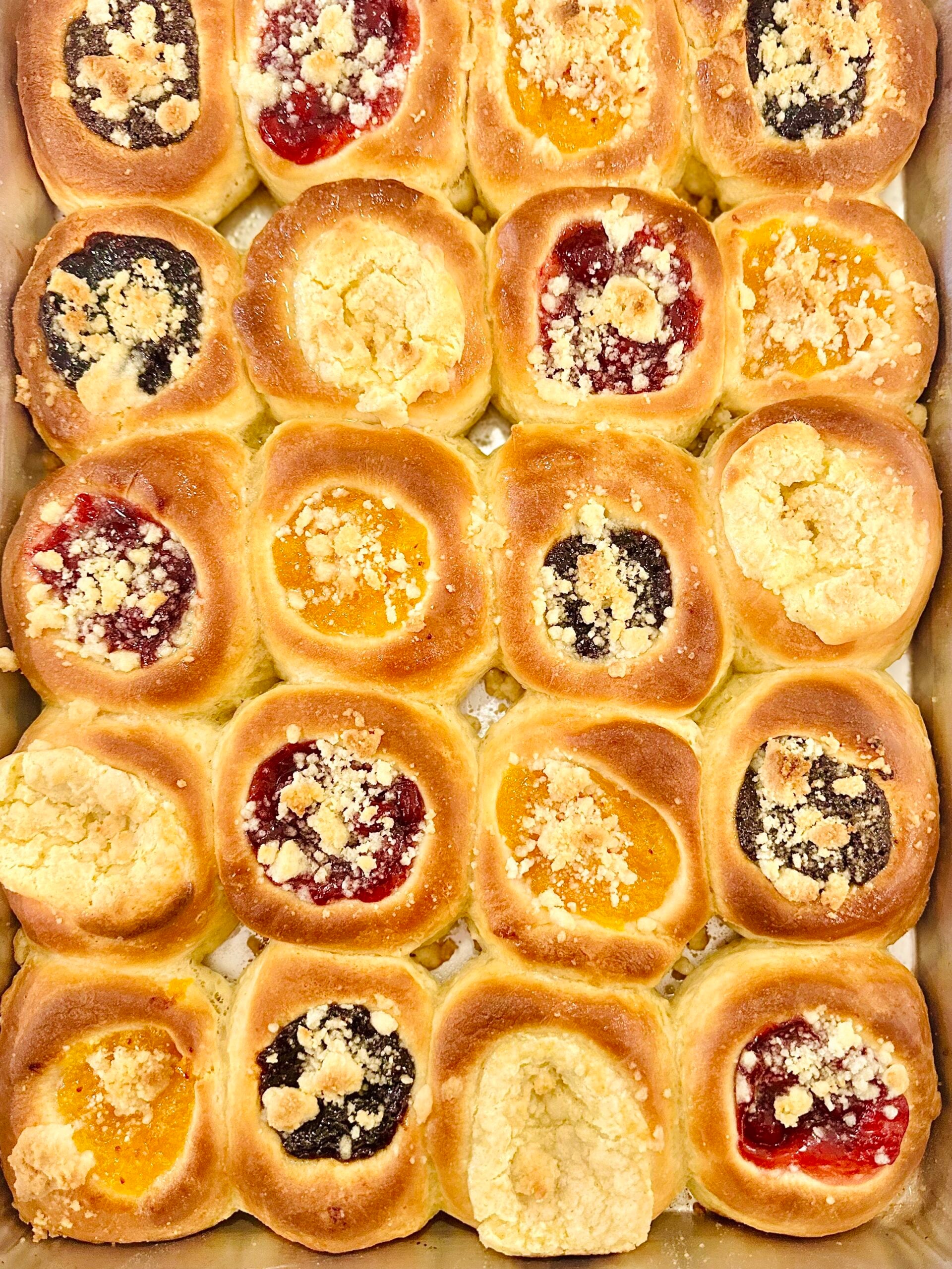 Overhead close-up of assorted baked Texas Czech kolaches topped with posypka.