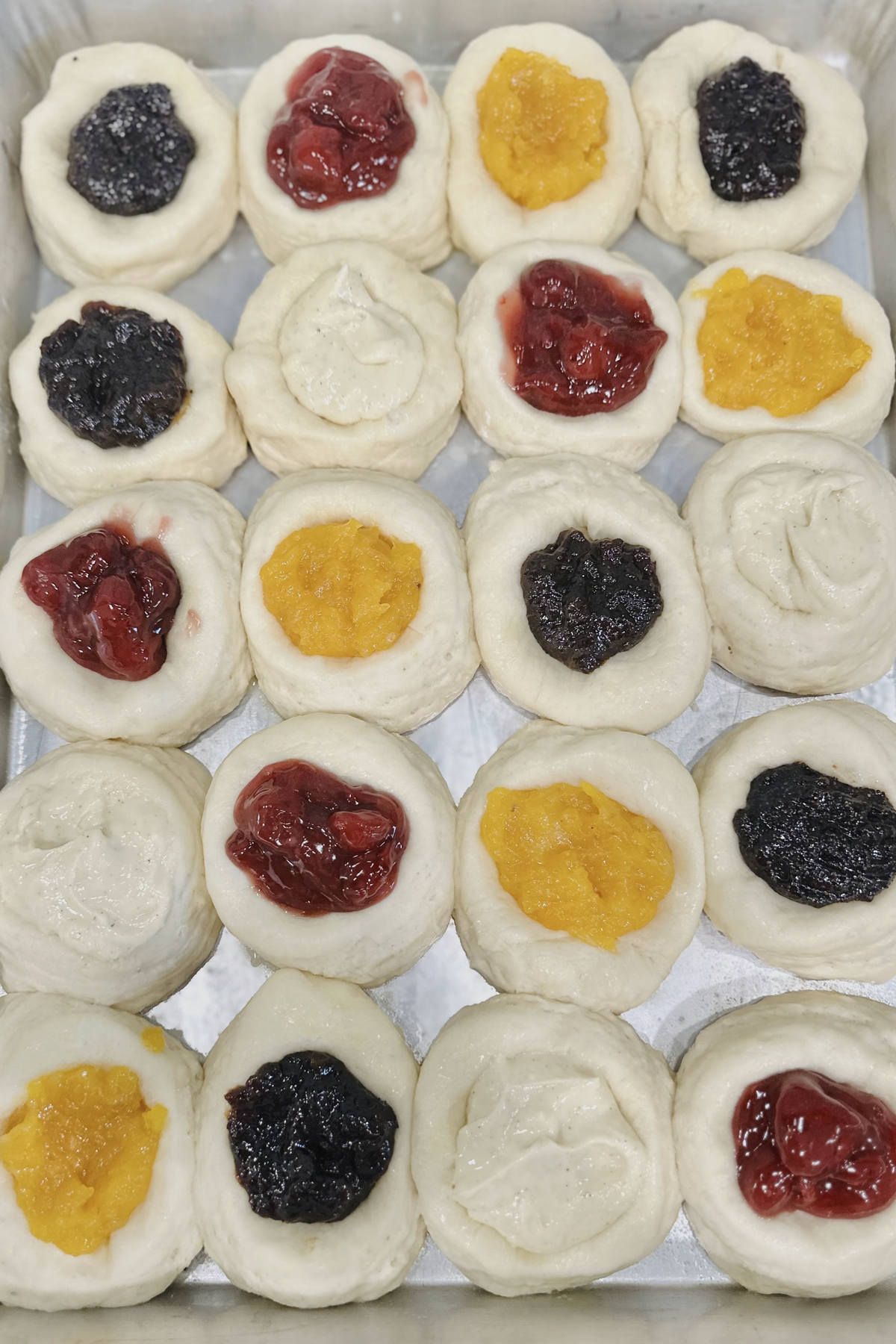 Kolache dough rounds filled with cherry, apricot, poppy seed, and cream cheese fillings.