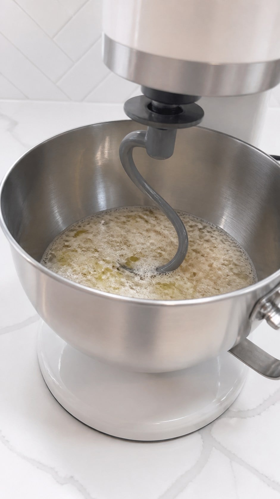 Poolish dispersed with water and olive oil in a stand mixer.