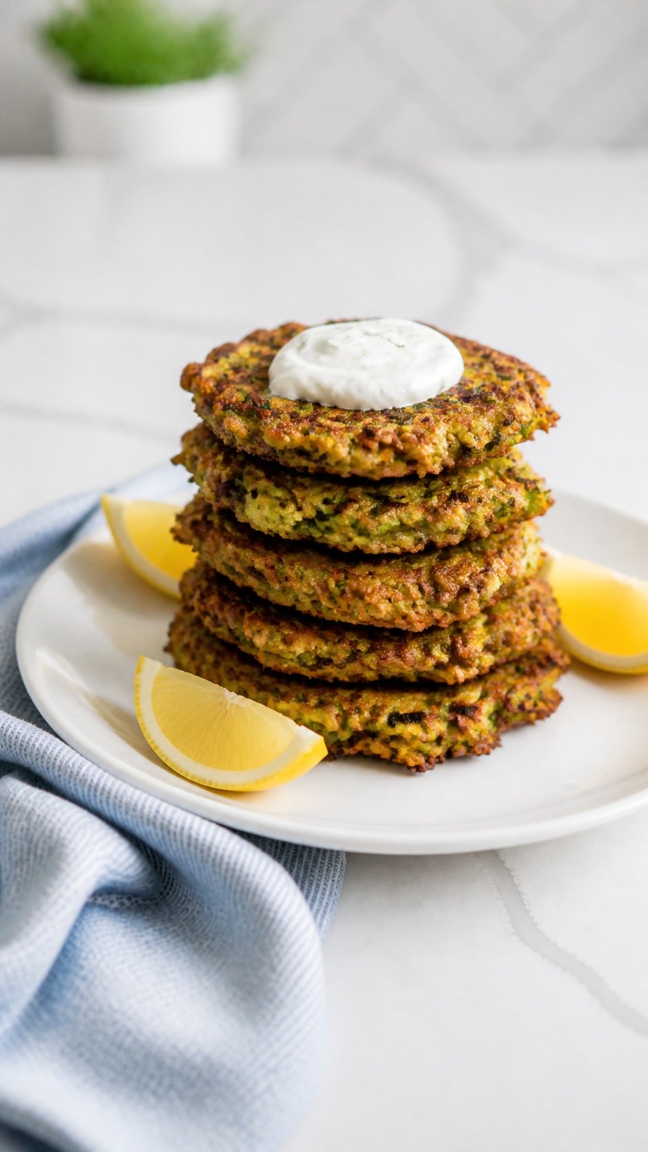 Stack of crispy zucchini fritters with deeply browned edges and visible zucchini shreds.