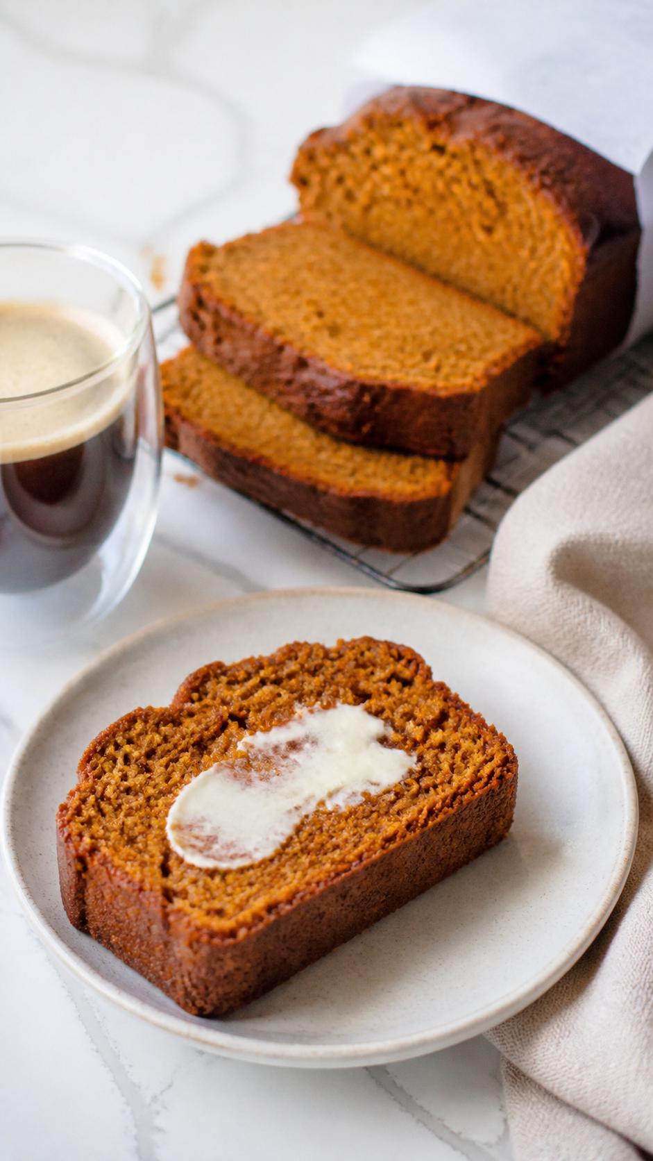 Amish pumpkin bread slices served with butter and coffee