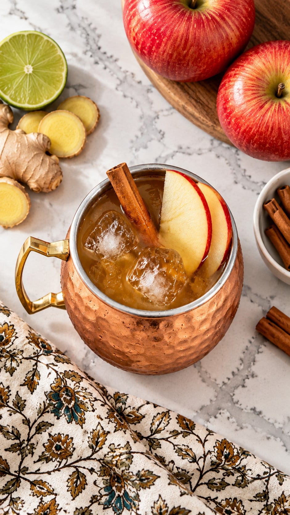 Overhead view of an iced apple cider mule with apple garnish