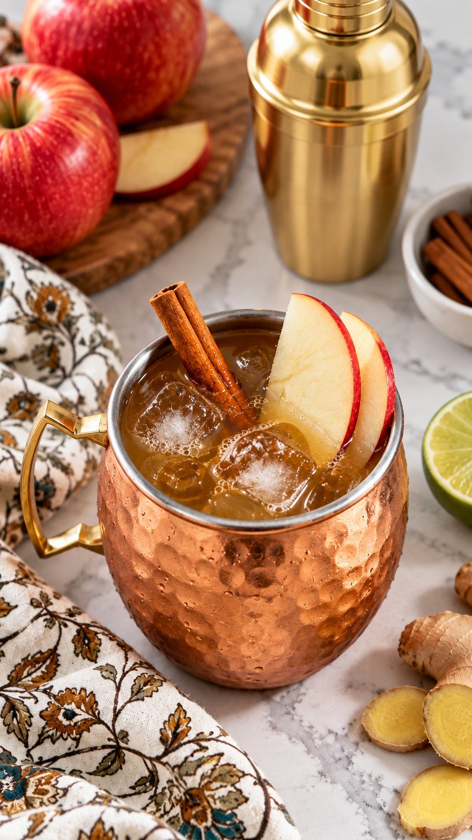 Finished cider mule garnished with apple slices and a cinnamon stick