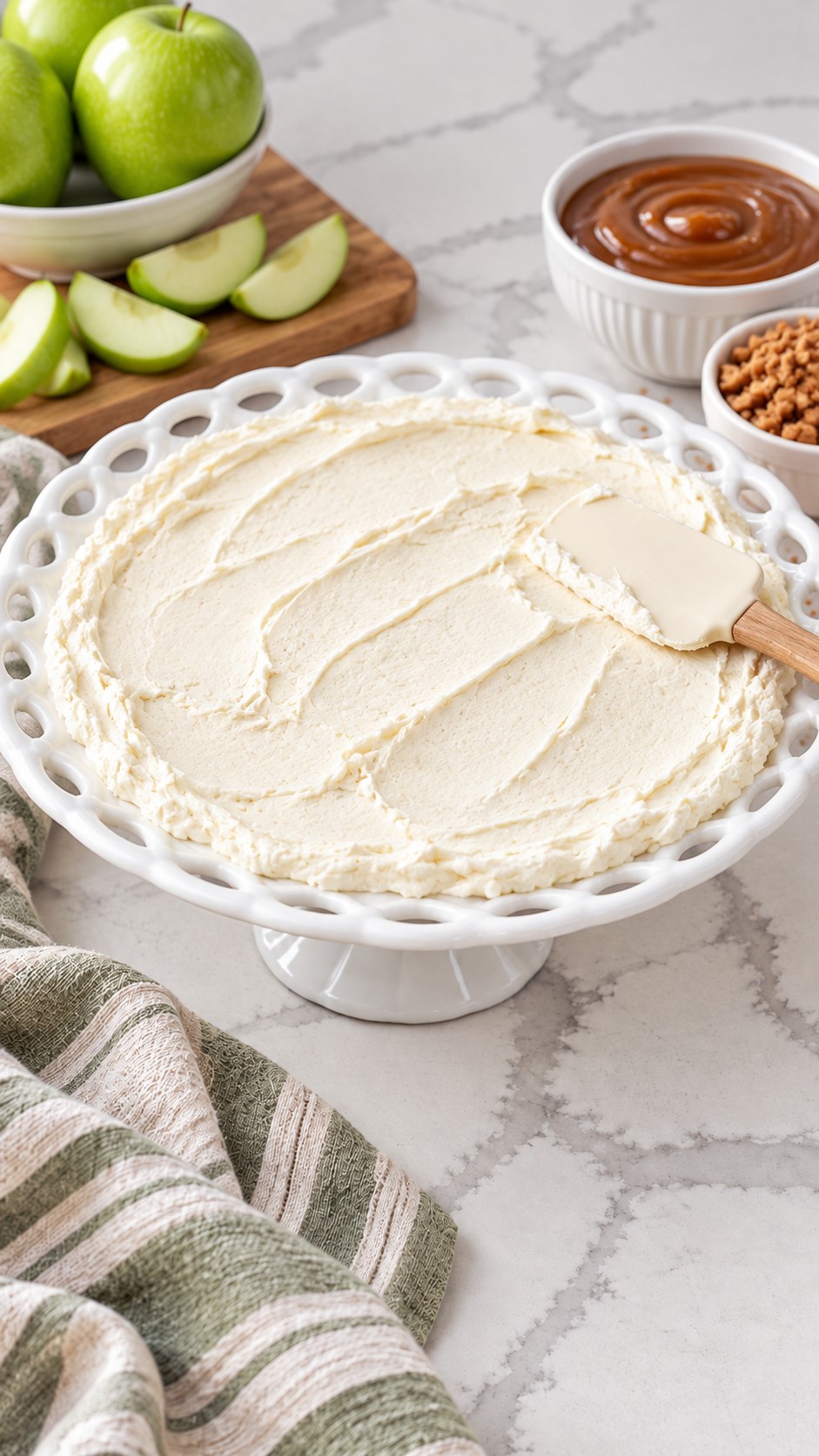 Sweetened cream cheese spread in an even layer on a shallow white platter