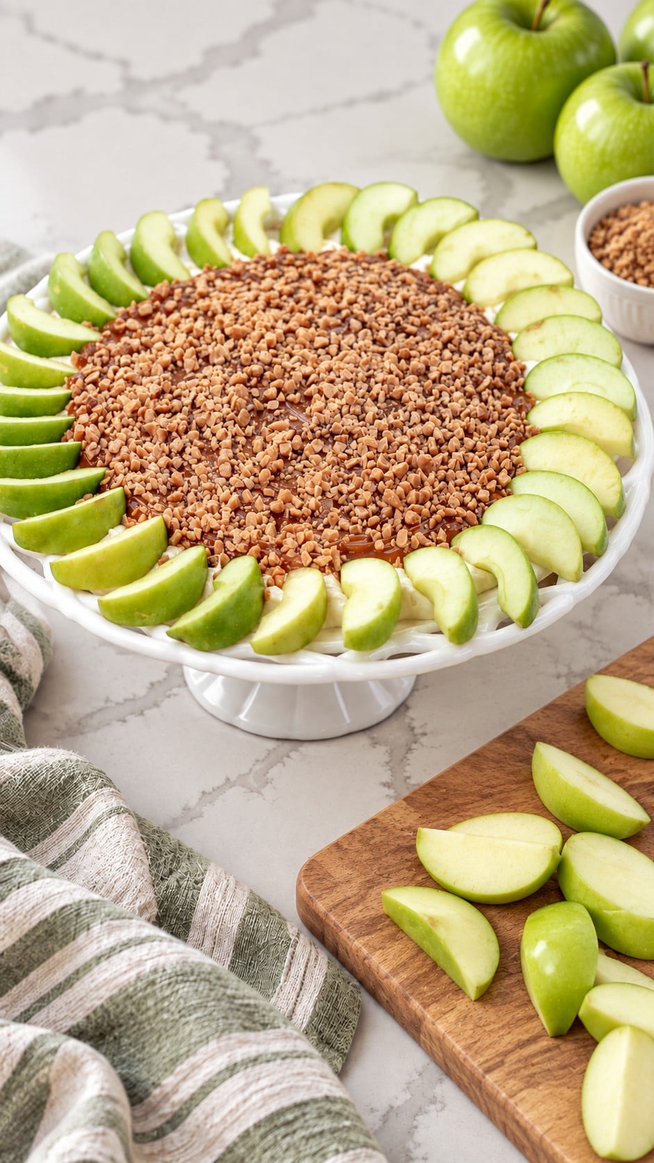 Fresh Granny Smith wedges beside the finished caramel apple dip