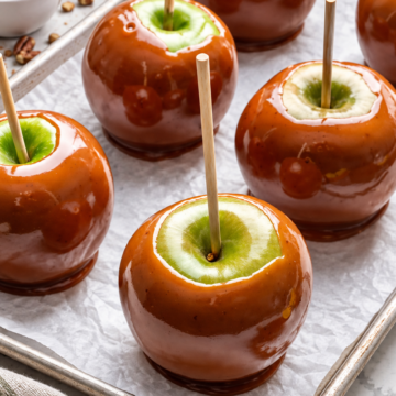 Granny Smith apples coated in glossy brown sugar caramel with wooden sticks