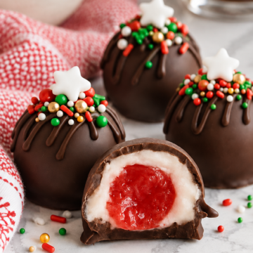 Chocolate covered cherry cordials arranged on a white plate