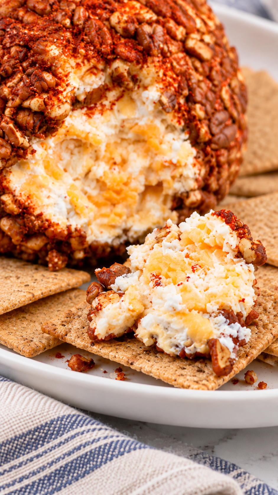 Close-up of cottage cheese curds and grated cheddar inside the chili-pecan cheese ball.